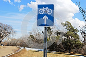 Bike route ahead sign along a scenic street