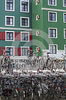 Bike`s parking with many bikes on the street. Street bike`s parking in the Dutch city Zaandam with green houses