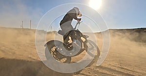 Bike, sand and power with man off road for action, competition or performance on dirt track. Dust, motorcycle and summer