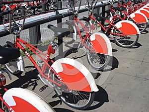 Bike Sharing in Barcelona, Spain. Long row of red and white public bikes