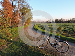 Bike standing on the road in the Serio River Park in Lombardy, Italy photo