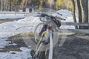 Bike standing on a wooden trench with desserted house in a background in snowland with beautiful landscape