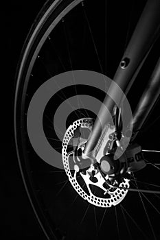 Bike tire, axel, hub and spokes black background