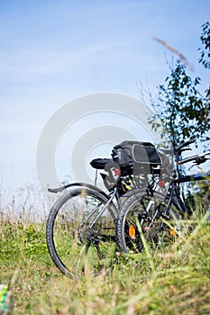 Bike tour: Bikes, grass and blue sky. Outdoors, text space