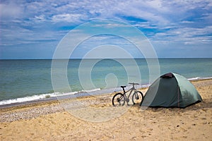 Bike and tourist camp on a sunny seashore