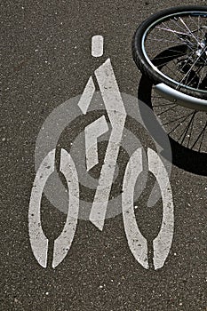 Bike wheel and symbol/sign on asphalt