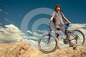 Bikeer traveler with bicycle portrait in Himalayas mountain