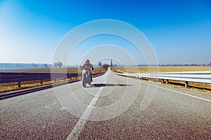 Biker in action riding on the road spring and summer outdoors leisure season and freedom conceptt- toned with a trendy filter