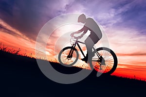 Biker on bike with sky background on sunsetSilhouette of a biker on bike with sky background on sunsetSilhouette