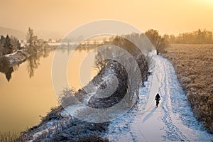 Biker cycling on the path alongside a river