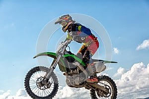 Biker does the trick and jumps in the air. Extreme concept, adrenaline. Copy space. Sky background