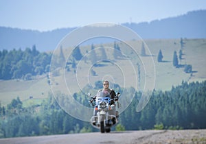 Biker driving his cruiser motorcycle on road