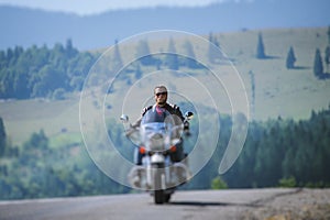 Biker driving his cruiser motorcycle on road