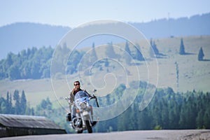 Biker driving his cruiser motorcycle on road