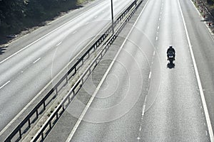 Biker On An Empty Highway