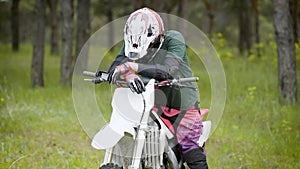 Biker on enduro bike at the forest. Man rider standing and waiting