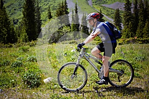 Biker on footpath in mountains