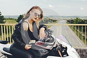 Biker girl in a leather clothes on a motorcycle