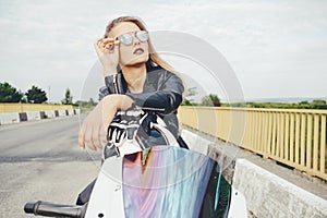 Biker girl in a leather clothes on a motorcycle