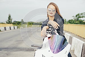 Biker girl in a leather clothes on a motorcycle