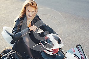 Biker girl in a leather clothes on a motorcycle