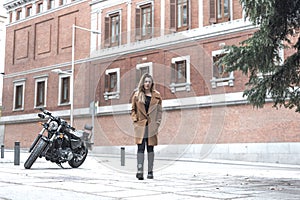 Biker girl in a leather jacket on a motorcycle