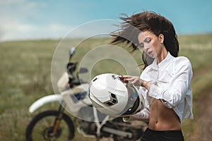 Biker girl next to a motorcycle