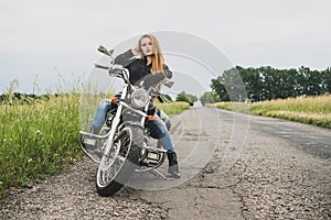 Biker girl posing on a motorcycle.