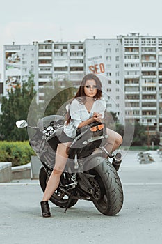 Biker girl rides a motorcycle in the rain. First-person view