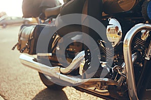 Biker girl riding on a motorcycle. Bottom view of the legs in leather boots. Leg girl with heels on a bike. The power of women.