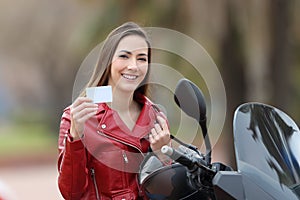Biker girl showing a blank credit card