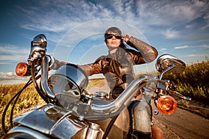 Biker girl sitting on motorcycle