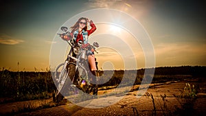 Biker girl sitting on motorcycle