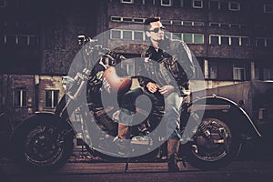 Biker and his bobber style motorcycle