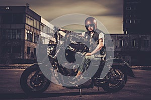 Biker and his bobber style motorcycle