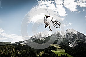 Biker jumps a high stunt photo