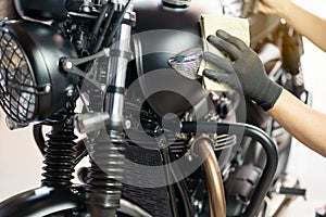 Biker man cleaning motorcycle , Polished and coating wax on fuel tank. repair and maintenance motorcycle concept