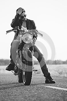 Biker man sits on a bike