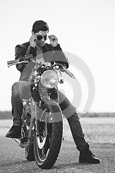 Biker man sits on a bike