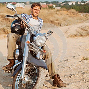 Biker man sits on a bike