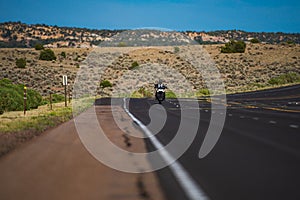 Biker on motorbike, Route 66. American landscape with asphalt road to horizon. Motorbike on the road riding.