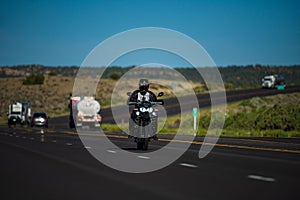 Biker on motorbike, Route 66. Natural american landscape with asphalt road to horizon. Motorbike on the road riding.