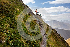 Biker pushes his bicycle up in high Caucasus mountains