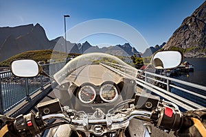 Biker rides on road in Norway. First-person view