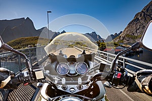 Biker rides on road in Norway. First-person view