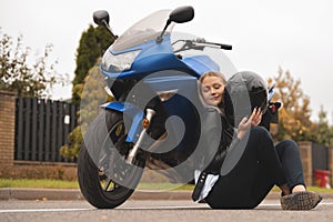 Biker sexy woman sitting about motorcycle. Outdoor lifestyle portrait