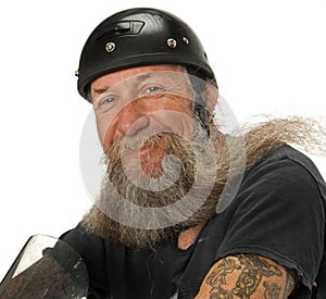 Biker smiles as the wind blows through his beard