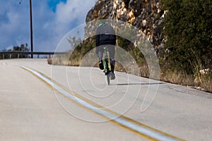 Biker uphill road on the mountain trying