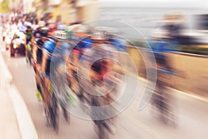 Bikers during bike race on city street, radial blurred zoom with