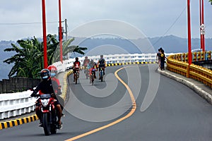 Bikers and motorcycle riders cross the Tumana Bridge in Marikina City.